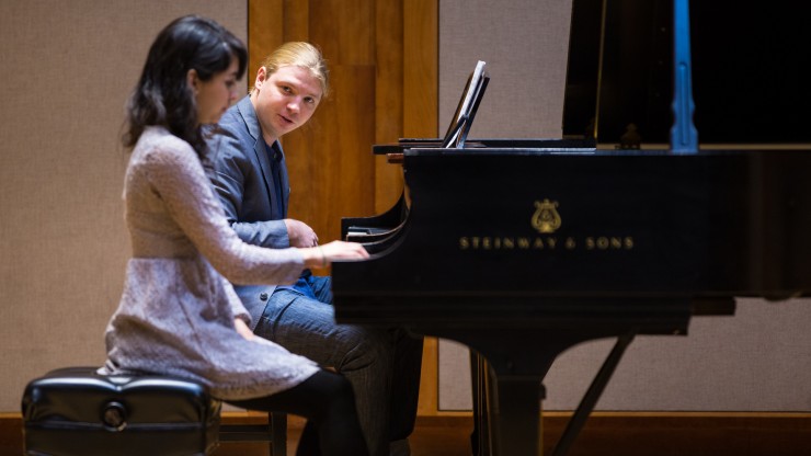 A piano student and teacher in the middle of a piano masterclass